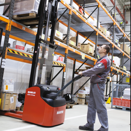 Manitou stacker working in warehouse 